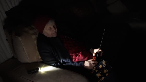 Ουκρανία Γιαγιά Κρατά Ραδιόφωνο Χέρια Που Κάθονται Στο Σκοτάδι Μπλακάουτ — Αρχείο Βίντεο