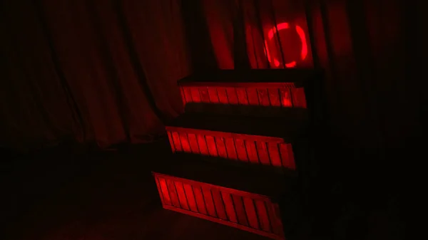 Red night LED lighting wooden stairs on the stage of theatre and red link background.