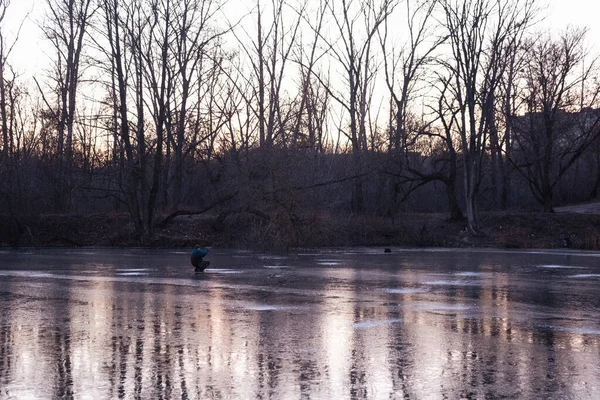 winter sport, winter fishing outside on the ice on the river or lake.