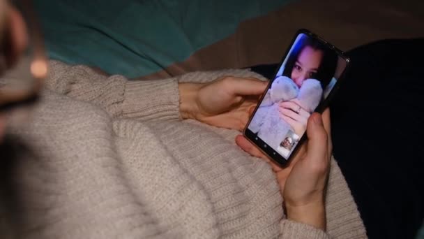 Young Man Sitting Sofa Holding Smartphone Communicating Girl Friend Show — Stockvideo