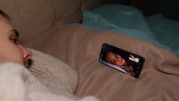 Young Man Lie Sofa Holding Smartphone Communicating Girl Friend Show — Stockvideo