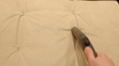 Close-up of a furniture vacuum cleaner and a dirty sofa. Cleaning and house cleaning, housekeeper or special service to keep house clean. Laundry cloth