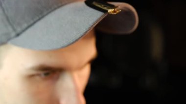 Closeup View Of barber using hair clip to fix the hair for cut and styling it. Hairdresser use pinsn hair salon. service in a modern barbershop in a dark key lightning with warm light Slow motion.