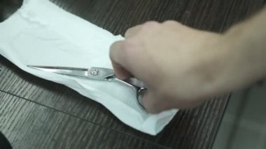 Kuaförlerin işyeri. Berberin elinin yakın çekimini yap. Makası al. Yakın çekim. Profesyonel kuaför aletleri Yavaş çekim.