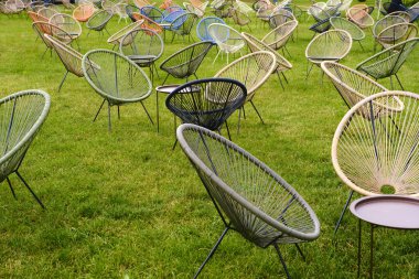 Yeşil çimen arka planında kain sandalyeler.