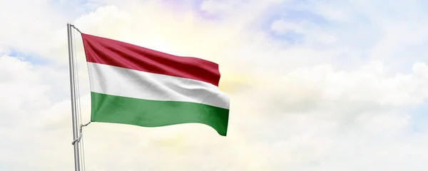 Hungary flag waving on sky background. 3D Rendering