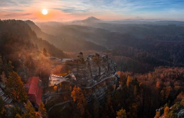 Hrensko, Czech Republic - Aerial panoramic view of the beautiful Pravcicka Brana (Pravcicka Gate) in Bohemian Switzerland National Park, the biggest natural arch in Europe with a warm autumn sunrise
