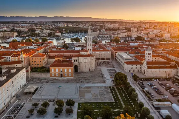 stock image Zadar, Croatia - Aerial view of the Forum of the old town of Zadar with the Church of St. Donatus and the bell tower of the Cathedral of St. Anastasia on a summer morning with golden sunrise