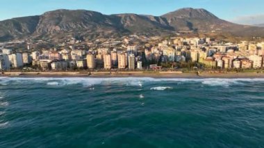 Bir adam kumsal mavisi deniz dokusunda koşar.