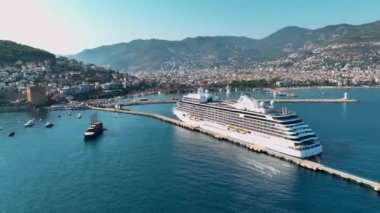 Güneşli bir günde Alanya Türkiye limanında büyük bir yolcu gemisi duruyor.