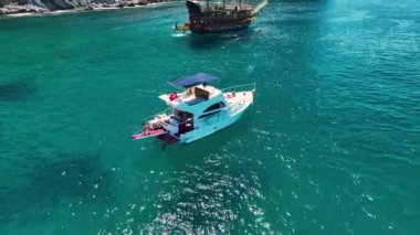 Büyük bir yat denizde duruyor. Arka planda muhteşem yaz atmosferi var.