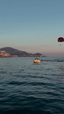 Su paraşütü denizdeki insanları kırmızı paraşütle gezdirir.