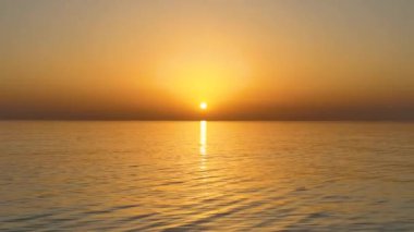 People sit on the beach and watch the sunset 4K