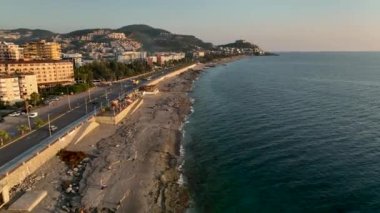 showing the Turkish coastal beach front and water park in the summer time on a hot sunny day