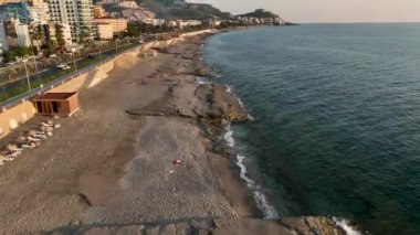 showing the Turkish coastal beach front and water park in the summer time on a hot sunny day