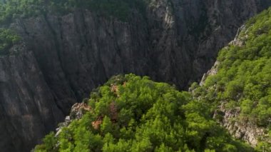 Tourist woman hiker on cliff against backdrop of gorge. Amazing Tazi Canyon, Turkey. Greyhound Canyon aerial view