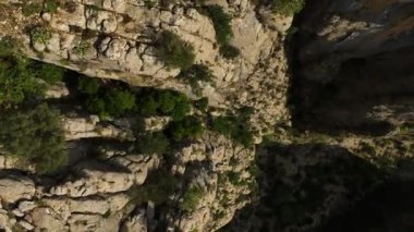 Tourist woman hiker on cliff against backdrop of gorge. Amazing Tazi Canyon, Turkey. Greyhound Canyon aerial view