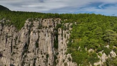 Tourist woman hiker on cliff against backdrop of gorge. Amazing Tazi Canyon, Turkey. Greyhound Canyon aerial view