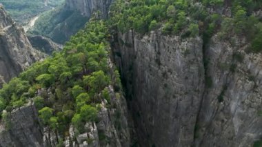 Tourist woman hiker on cliff against backdrop of gorge. Amazing Tazi Canyon, Turkey. Greyhound Canyon aerial view