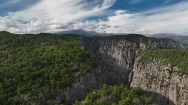 Tourist woman hiker on cliff against backdrop of gorge. Amazing Tazi Canyon, Turkey. Greyhound Canyon aerial view