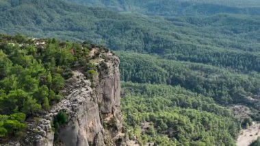 Tourist woman hiker on cliff against backdrop of gorge. Amazing Tazi Canyon, Turkey. Greyhound Canyon aerial view