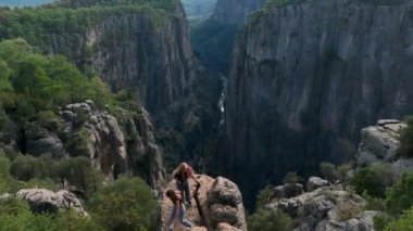 Tourist woman hiker on cliff against backdrop of gorge. Amazing Tazi Canyon, Turkey. Greyhound Canyon aerial view