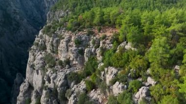Tourist woman hiker on cliff against backdrop of gorge. Amazing Tazi Canyon, Turkey. Greyhound Canyon aerial view