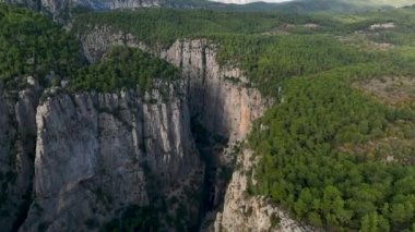 Tourist woman hiker on cliff against backdrop of gorge. Amazing Tazi Canyon, Turkey. Greyhound Canyon aerial view