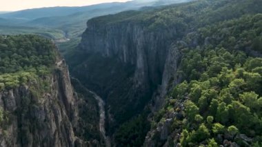 Tourist woman hiker on cliff against backdrop of gorge. Amazing Tazi Canyon, Turkey. Greyhound Canyon aerial view