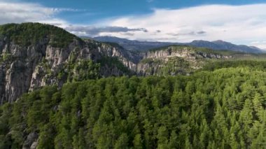 Tourist woman hiker on cliff against backdrop of gorge. Amazing Tazi Canyon, Turkey. Greyhound Canyon aerial view