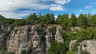 Tourist woman hiker on cliff against backdrop of gorge. Amazing Tazi Canyon, Turkey. Greyhound Canyon aerial view