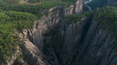 Tourist woman hiker on cliff against backdrop of gorge. Amazing Tazi Canyon, Turkey. Greyhound Canyon aerial view