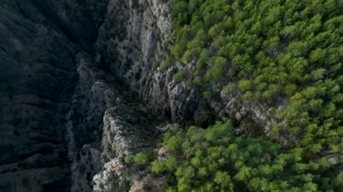 Tourist woman hiker on cliff against backdrop of gorge. Amazing Tazi Canyon, Turkey. Greyhound Canyon aerial view