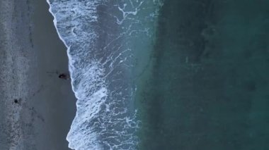 aerial view from drone at low altitude on sunset summer. Motion of small waves. Sea idyll. Relax 4 K