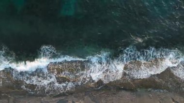 aerial view from drone at low altitude on sunset summer. Motion of small waves. Sea idyll. Relax 4 K
