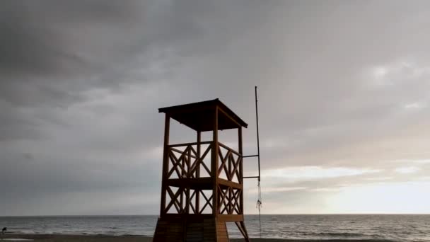 救助塔に海の素晴らしい背景にピンクの夕日 — ストック動画