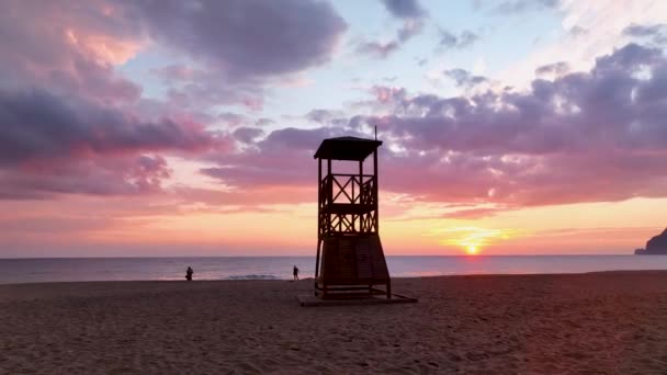 救助塔に海の素晴らしい背景にピンクの夕日 — ストック動画