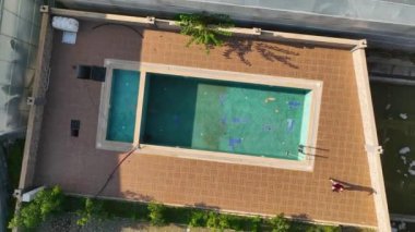Dirty pool aerial view ,green water no people cold