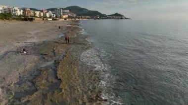 aerial view from drone at low altitude on sunset summer. Motion of small waves. Sea idyll. Relax 4 K