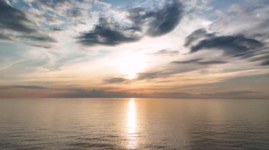 aerial view from drone at low altitude on sunset summer. Motion of small waves. Sea idyll. Relax 4 K