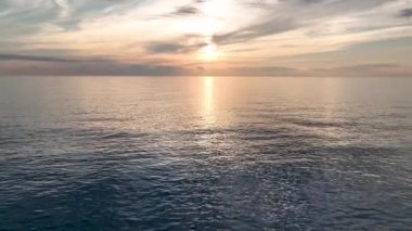 aerial view from drone at low altitude on sunset summer. Motion of small waves. Sea idyll. Relax 4 K