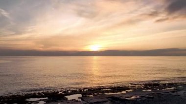 aerial view from drone at low altitude on sunset summer. Motion of small waves. Sea idyll. Relax 4 K