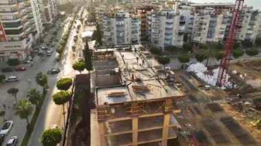 Construction site on the shores of the Mediterranean Sea, a crane lifts the metal structure
