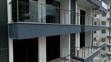 Construction site on the shores of the Mediterranean Sea, Drone flies smoothly along the facade aerial view 4K