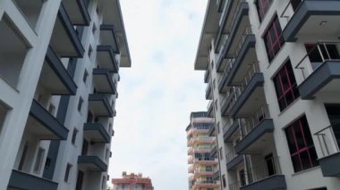 Construction site on the shores of the Mediterranean Sea, Drone flies smoothly along the facade aerial view 4K