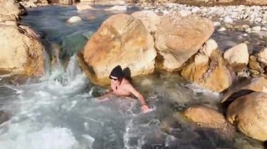 Aerial view rest in cold water, orange stones