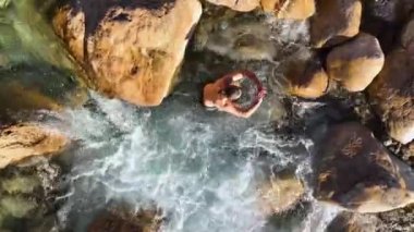 The young man is very seriously adjusted. The guy enjoys the nature and breathes fresh air aerial view 4K