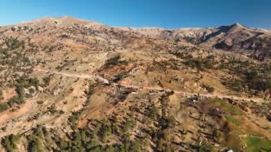 The water is rushing along colorful stones aerial view 4K flowing in the deep lake