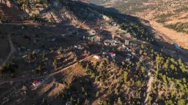 Beautiful landscape of a small village on the banks of a mountain river aerial view