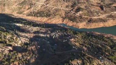 Beautiful landscape of a small village on the banks of a mountain river aerial view